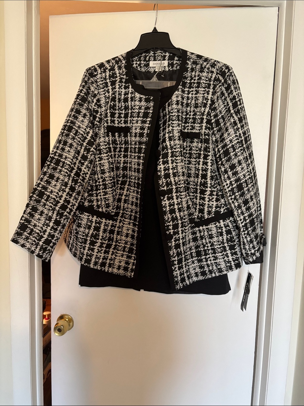 Danilo Black & White Tweed Collarless Check Blazer with a black skirt.